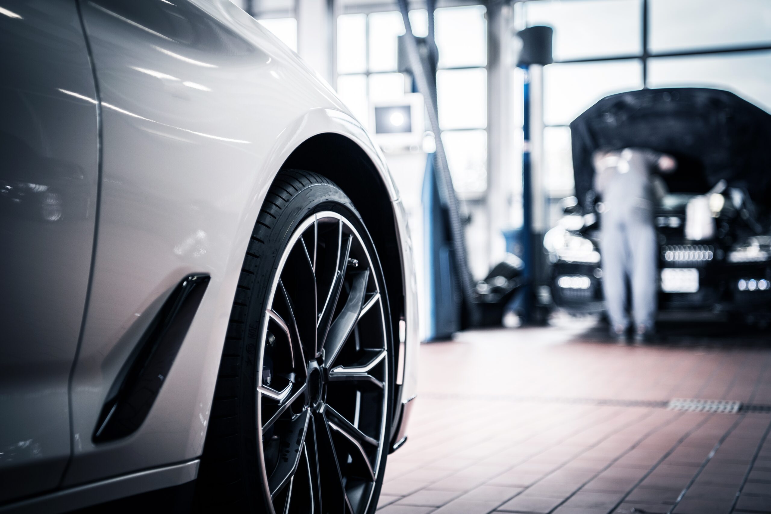 ASE-certified mechanic performing a routine maintenance check under the hood of a car.