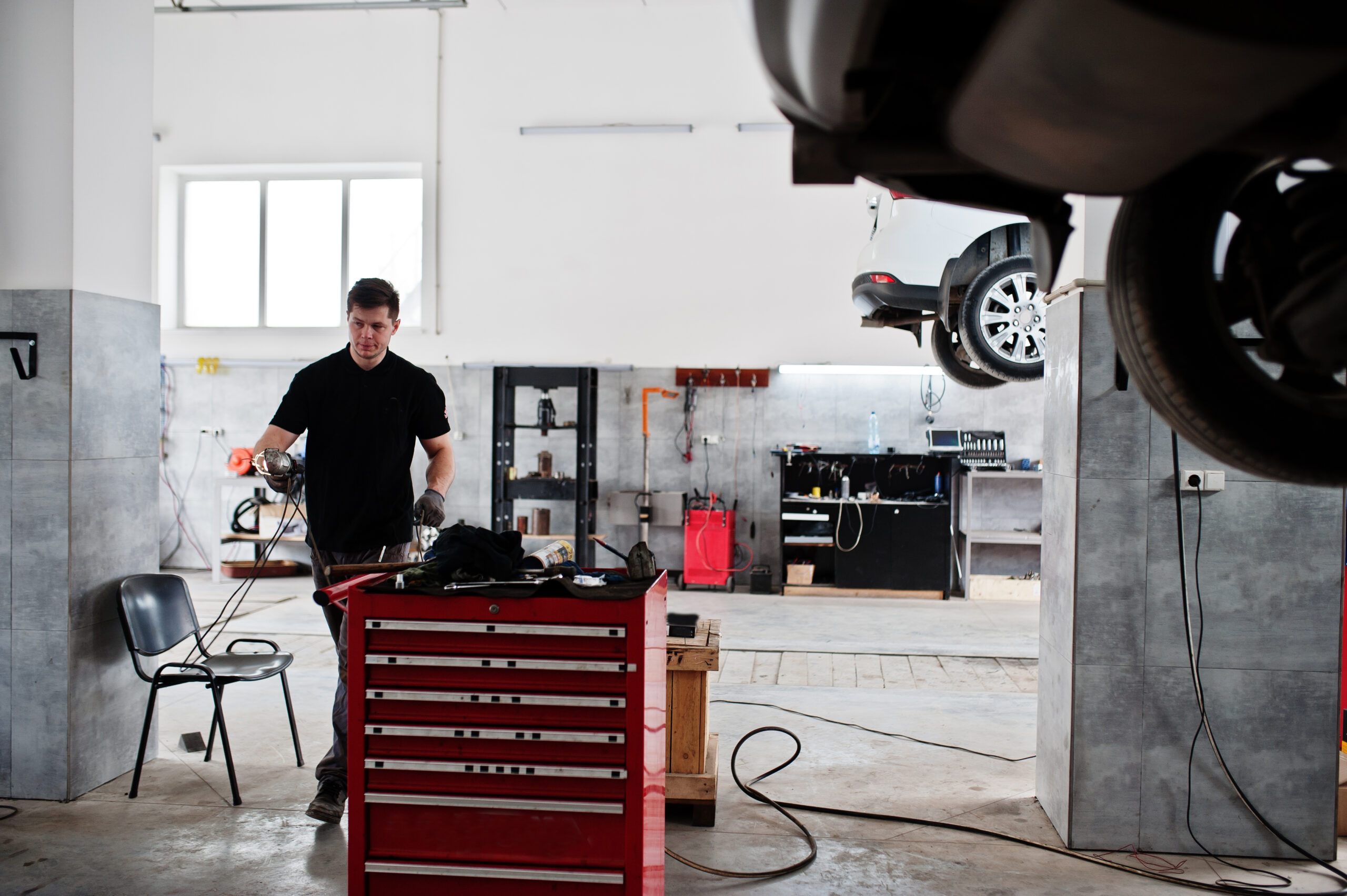 Car undergoing a thorough inspection on a hydraulic lift at Music City Auto Repairs