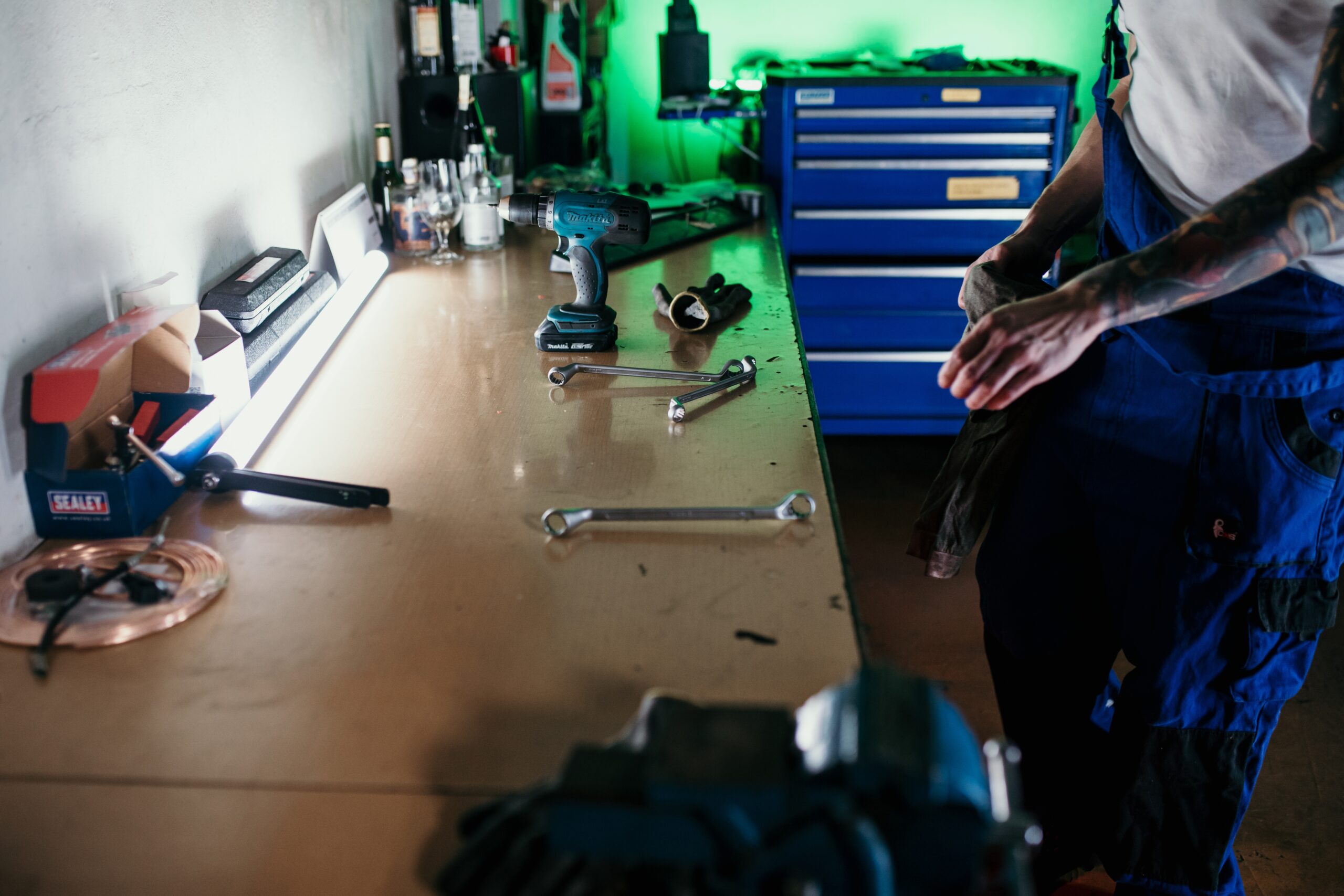 A cluttered yet organized mechanic's workbench overflowing with tools of various shapes and sizes.