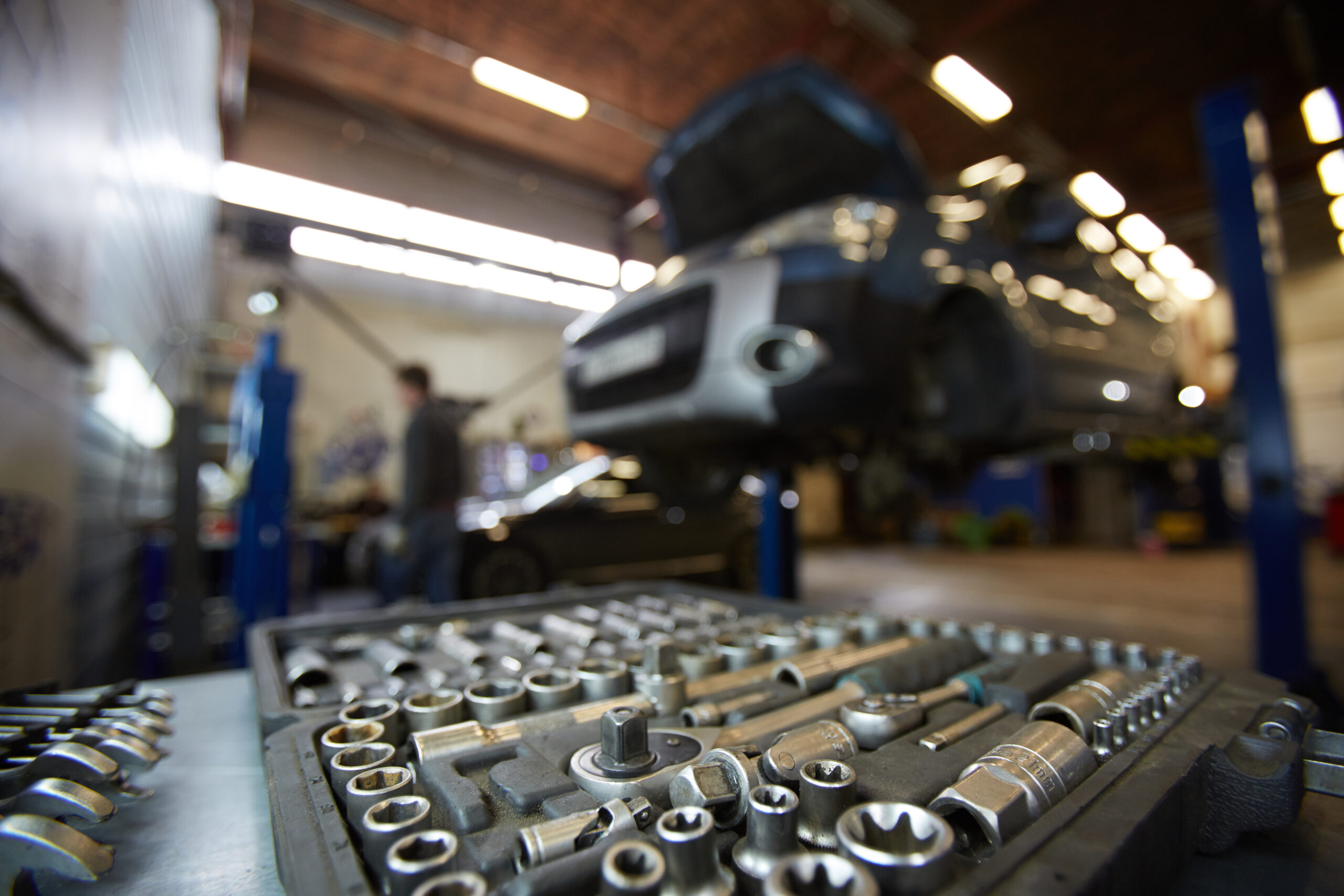 A well-organized tool chest containing a variety of wrenches, sockets, screwdrivers, and other tools used by car mechanics.