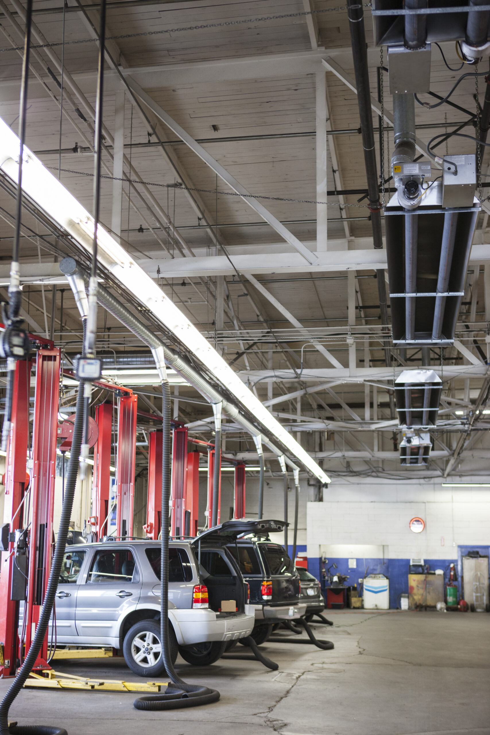 A bustling auto repair shop in Seattle with rows of cars and trucks being serviced.