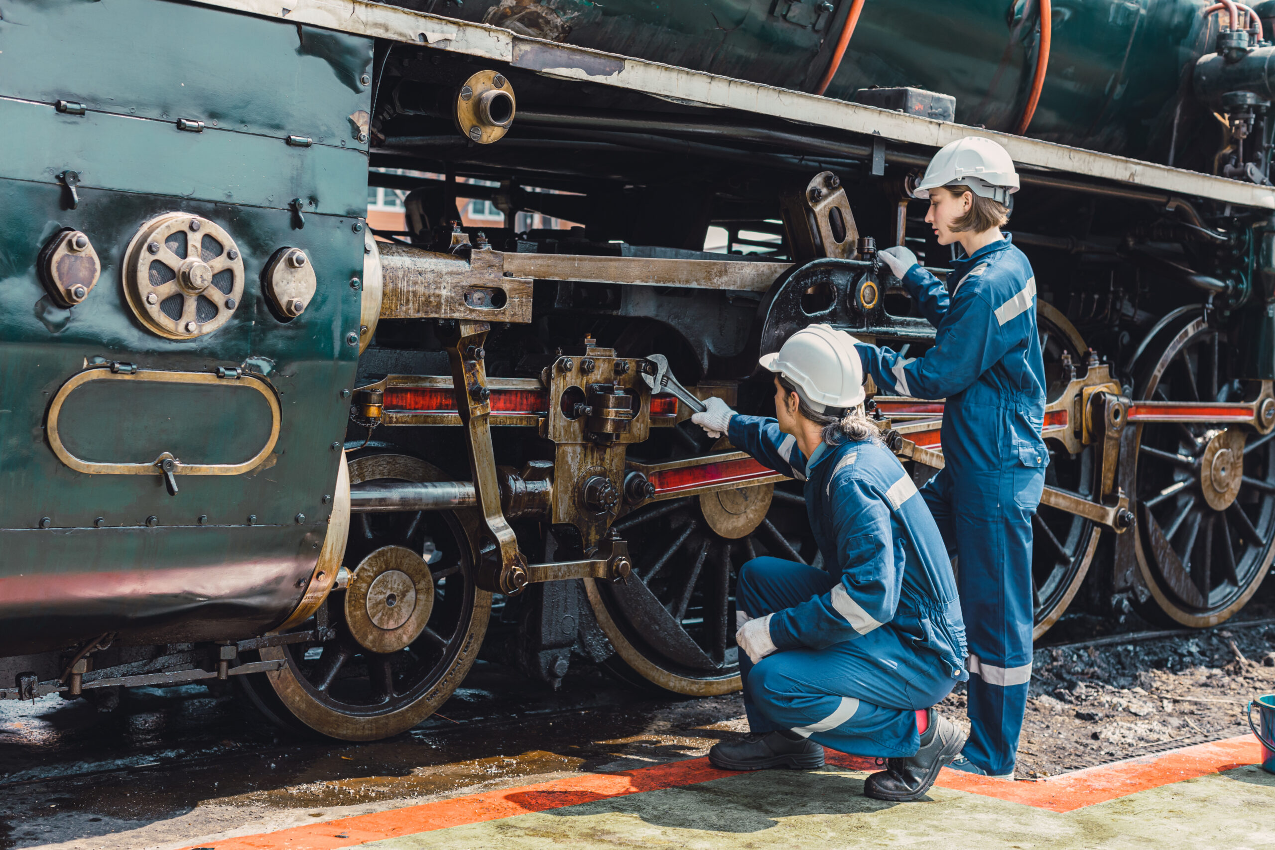 A team of automotive engineers collaborates in a workshop, analyzing data and discussing potential improvements to a vehicle's design and performance.